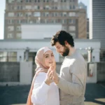 Muslim couple holding hands after marriage counseling in NYC, embracing renewed trust and cultural understanding in their relationship.