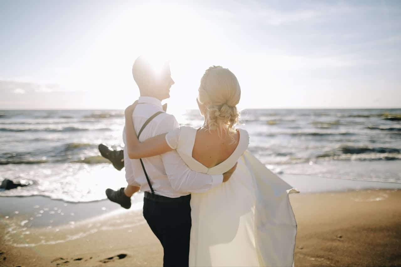 Couple walking together along the beach at sunset symbolizing emotional connection and relationship growth through marriage counseling
