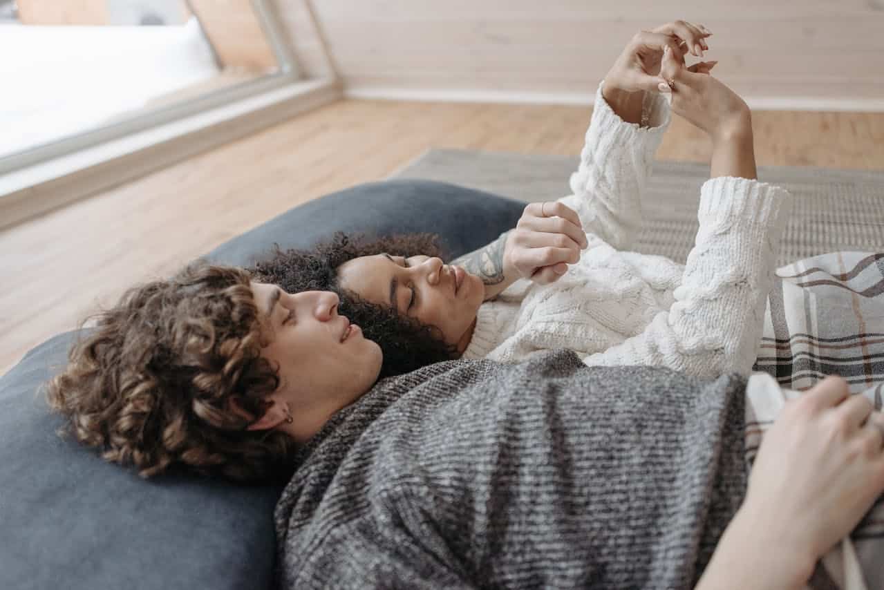 Couple relaxing together at home representing comfort and communication often supported through online marriage counseling sessions
