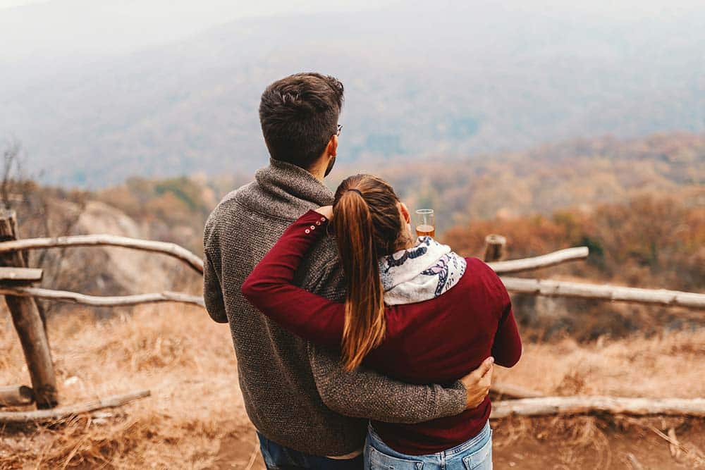 A happy Caucasian couple enjoying the view together outdoors