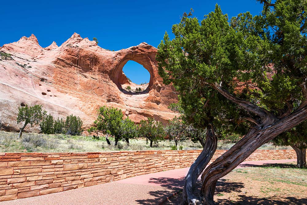 A stone wall with a hole in the middle of it