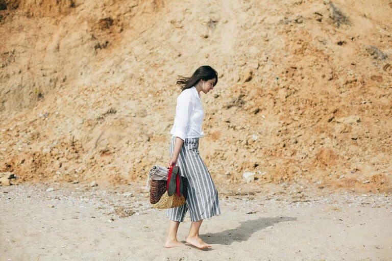 Woman walking on a sandy beach