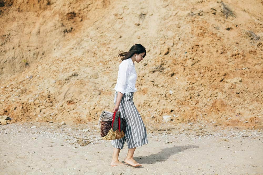 Woman walking on a sandy beach